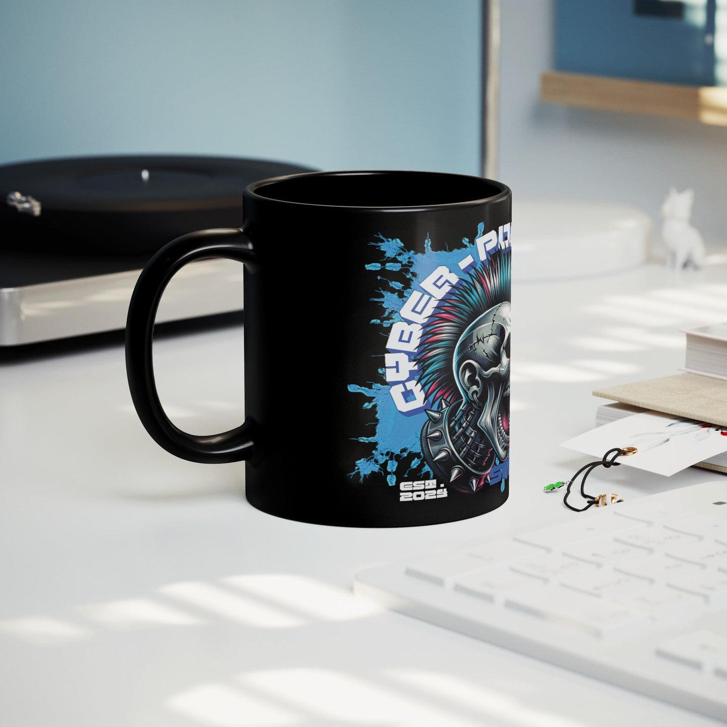 A Black Mug (11 oz | 3.25 dl) black Mug next to the keyboard with Cyber Punk Skull Design. It is a pcs of FBD Cyber Punk Collection Products. Each product of mentioned collection is limited edition in  99 pcs. Design: FBD - Federal Bureau of Design.